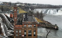 Cohoes hydroelectric plant with penstocks on left of picture and Cohoes Falls in top right